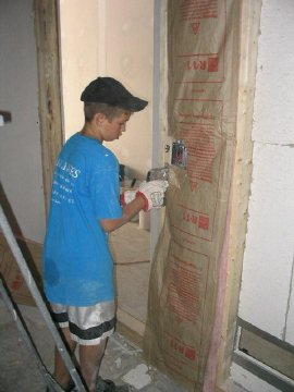 Youth Works! volunteer insulates a music studio