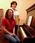 Dottie and student use a newly-restored piano